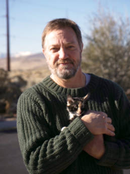 Photo of board member John Boone holding a kitten.